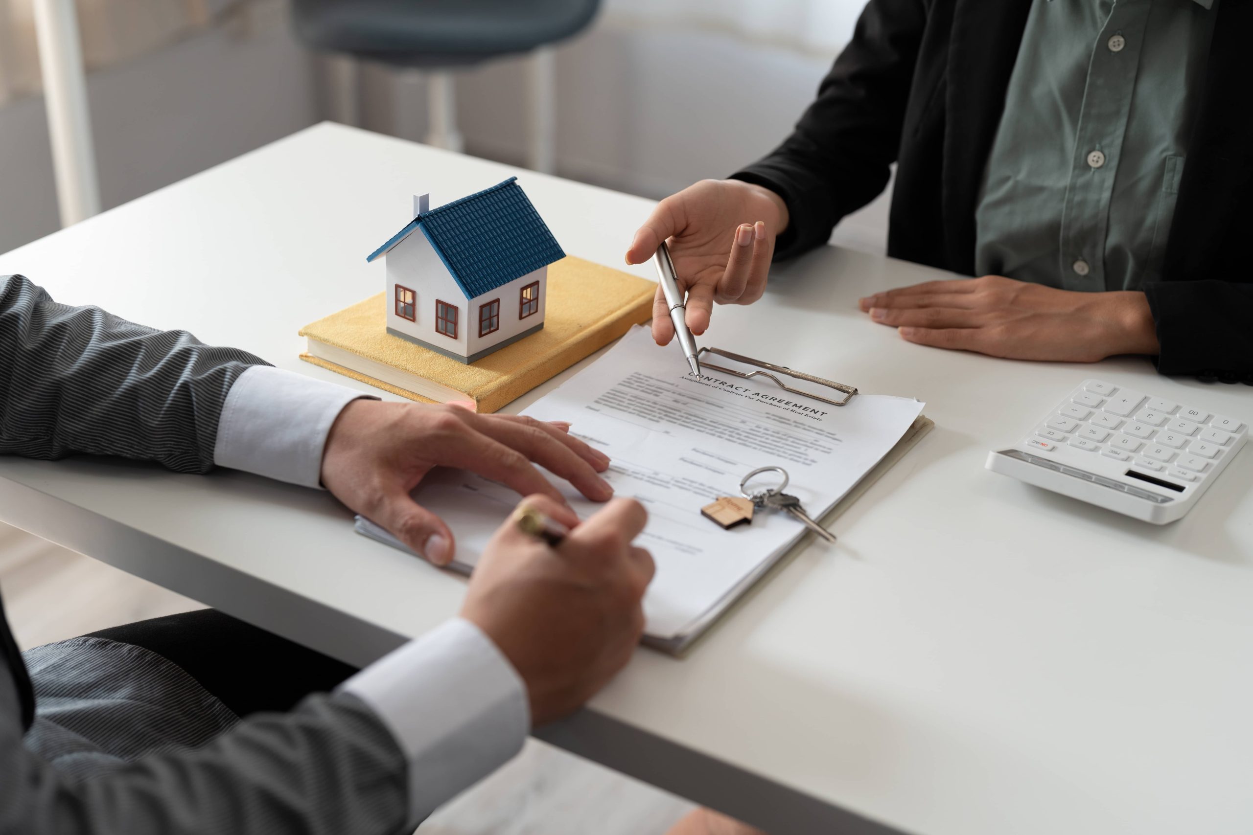 vecteezy_real-estate-agent-holding-house-key-to-his-client-after_8572449